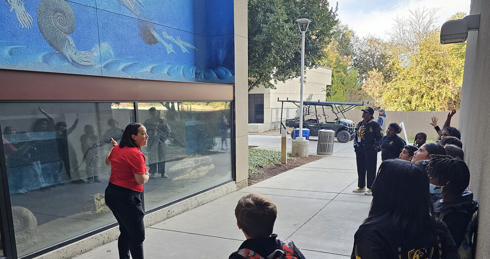 Dr. Mara Brady gives a mural tour to 4th graders