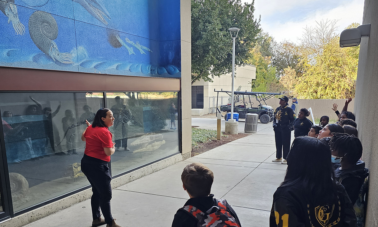 Dr. Mara Brady gives a mural tour to 4th graders