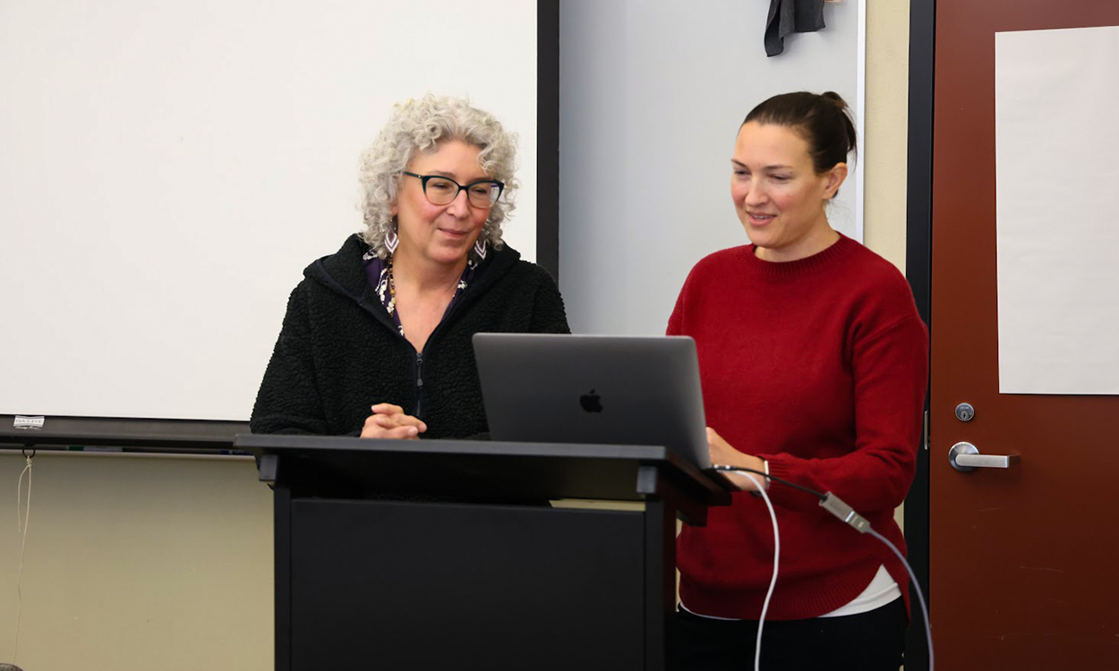 Psychology professors Dr. Constance Jones and Andrea Wiemann consult their notes during the TA bootcamp